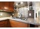 Close-up of a kitchen with custom backsplash, granite countertops, and stainless steel appliances, perfect for culinary adventures at 1514 Maplewood Ct, Woodstock, GA 30189