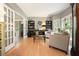 Inviting living room with wood floors, bookshelves, and abundant natural light at 1514 Maplewood Ct, Woodstock, GA 30189