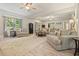 Spacious living room featuring hardwood floors, neutral color palette, and large windows with views of the outdoors at 1514 Maplewood Ct, Woodstock, GA 30189