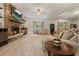 Inviting living room with stone fireplace, wood floors, and comfortable seating arrangement, a cozy space for relaxation at 1514 Maplewood Ct, Woodstock, GA 30189