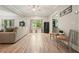Bright and airy living room with wood floors and view to another room at 1514 Maplewood Ct, Woodstock, GA 30189
