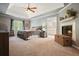 Spacious bedroom featuring a trey ceiling, a fireplace, and view of the ensuite bathroom at 1514 Maplewood Ct, Woodstock, GA 30189