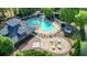 Aerial view of the neighborhood swimming pool, lounge area, and clubhouse at 1514 Maplewood Ct, Woodstock, GA 30189