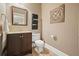 Stylish powder room with vanity, decorative mirror, and wood-look tile floor at 1514 Maplewood Ct, Woodstock, GA 30189