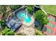 Aerial view of a community swimming pool with chairs, a spa, and a pool house surrounded by trees at 1514 Maplewood Ct, Woodstock, GA 30189