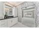 Modern bathroom with marble floors, black granite countertop, and access to main bedroom through doorway at 2444 Ballantrae Cir, Cumming, GA 30041