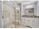 Luxurious bathroom with a glass enclosed shower, vanity with granite counters and tile flooring at 2444 Ballantrae Cir, Cumming, GA 30041