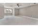Spacious bedroom with a geometric patterned carpet, a ceiling fan, and natural light at 2444 Ballantrae Cir, Cumming, GA 30041