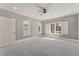 Light-filled bedroom with plantation shutters, a ceiling fan, and patterned carpeting at 2444 Ballantrae Cir, Cumming, GA 30041