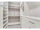 Walk-in closet with custom shelving, drawers, and ample storage space for clothes and accessories at 2444 Ballantrae Cir, Cumming, GA 30041