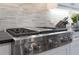 Close-up of the stovetop, complete with tile backsplash at 2444 Ballantrae Cir, Cumming, GA 30041