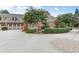 Charming brick home exterior with manicured landscaping, and a three car garage at 2444 Ballantrae Cir, Cumming, GA 30041