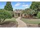 Inviting home featuring brick facade, lush lawn, and a stone walkway at 2444 Ballantrae Cir, Cumming, GA 30041