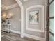 Elegant foyer with decorative niche, console table with lamps, and hardwood floors at 2444 Ballantrae Cir, Cumming, GA 30041