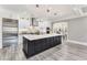 Bright, modern kitchen with a large center island, stainless steel appliances, and light wood flooring at 2444 Ballantrae Cir, Cumming, GA 30041