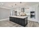 Spacious kitchen featuring a black island with white countertops and a suite of stainless steel appliances at 2444 Ballantrae Cir, Cumming, GA 30041