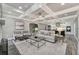 Spacious living room with coffered ceiling, fireplace, and open access to the kitchen at 2444 Ballantrae Cir, Cumming, GA 30041