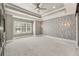 Spacious main bedroom with decorative accent wall, tray ceiling, recessed lighting and large windows at 2444 Ballantrae Cir, Cumming, GA 30041