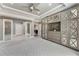 Large main bedroom with custom built-ins, tray ceiling, recessed lights, and access to walk-in closet at 2444 Ballantrae Cir, Cumming, GA 30041