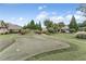 Backyard putting green in a community with lush green space and mature trees at 2444 Ballantrae Cir, Cumming, GA 30041