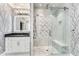 Luxurious walk-in shower with glass doors, marble tile, and rainfall shower head in modern bathroom at 2444 Ballantrae Cir, Cumming, GA 30041