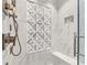 Intricate tile design featured in the modern walk-in shower, complete with built-in bench and sleek hardware at 2444 Ballantrae Cir, Cumming, GA 30041