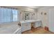 Bathroom featuring double sink vanity, soaking tub, tile floors, and natural light at 35 Kestrel Circle, Covington, GA 30014