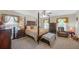Spacious bedroom features a four-poster bed, soft natural light, and comfortable sitting area at 35 Kestrel Circle, Covington, GA 30014