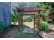 Wooden pergola structure in a backyard garden with a small grassy area at 35 Kestrel Circle, Covington, GA 30014