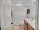 Bathroom with white shower curtain, double vanity, and wood drawers at 5460 Wheeler Ridge Rd, Auburn, GA 30011