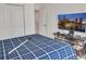 Bedroom with blue plaid bedding, TV, closet, and overhead lighting at 5460 Wheeler Ridge Rd, Auburn, GA 30011