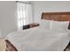 Bedroom with white bedding and wood furniture at 5460 Wheeler Ridge Rd, Auburn, GA 30011