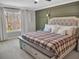 Well-lit bedroom showcasing the wall trim design and a decorative headboard at 5460 Wheeler Ridge Rd, Auburn, GA 30011