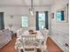 Charming dining room with white table and chairs, wood floors, and natural light at 5460 Wheeler Ridge Rd, Auburn, GA 30011