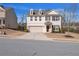 Charming two-story home with gray siding, brick accents and a two-car garage at 5460 Wheeler Ridge Rd, Auburn, GA 30011