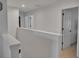 Bright upstairs hallway with neutral paint, leading to multiple rooms with closed doors at 5460 Wheeler Ridge Rd, Auburn, GA 30011