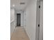 Neutral upstairs hallway leads to the bathroom with a shower, multiple bedrooms, and an attic at 5460 Wheeler Ridge Rd, Auburn, GA 30011