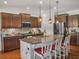 Modern kitchen with granite countertops, island seating, stainless appliances, and pendant lighting at 5460 Wheeler Ridge Rd, Auburn, GA 30011