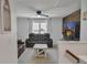 Upstairs living room with ceiling fan, wood accent wall, comfy brown leather sofa, and tv at 5460 Wheeler Ridge Rd, Auburn, GA 30011