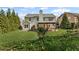 Well-manicured backyard showcases the home's exterior, patio, and lush green lawn and landscaping at 6655 Grove Meadows Ln, Cumming, GA 30028