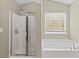 Bathroom with a walk-in shower, separate bathtub and large window at 6655 Grove Meadows Ln, Cumming, GA 30028