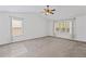 Bright bedroom with neutral carpet, large windows, and high ceilings create a serene atmosphere at 6655 Grove Meadows Ln, Cumming, GA 30028