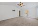 Spacious bedroom with high ceilings, neutral carpet, and a view of the en suite bathroom at 6655 Grove Meadows Ln, Cumming, GA 30028