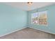 Bright bedroom with a large window offering natural light and light blue painted walls at 6655 Grove Meadows Ln, Cumming, GA 30028