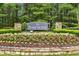 Welcoming Parkstone community sign surrounded by lush landscaping, stone accents, and colorful flowers at 6655 Grove Meadows Ln, Cumming, GA 30028
