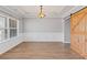 Neutral dining room with hardwood floors, barn door, and a tray ceiling at 6655 Grove Meadows Ln, Cumming, GA 30028