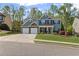 Charming two-story home with a three car garage and manicured lawn at 6655 Grove Meadows Ln, Cumming, GA 30028