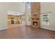 Open concept living room featuring a stone fireplace and chef's kitchen at 6655 Grove Meadows Ln, Cumming, GA 30028