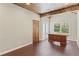 Bright office space with wooden ceiling beams, doors and a large wooden desk at 6655 Grove Meadows Ln, Cumming, GA 30028