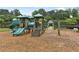 Fun-filled community playground with slides, climbing structures, and a soft mulch ground for safe play at 6655 Grove Meadows Ln, Cumming, GA 30028
